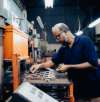 a man operating heavy machinery in an idustrial setting