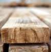 Close-up of stacked wooden planks showing the detailed texture and grain of the wood
